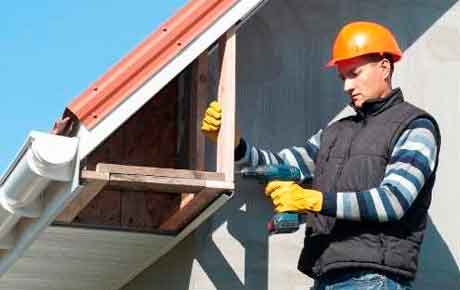 Operator repairing a damaged soffit