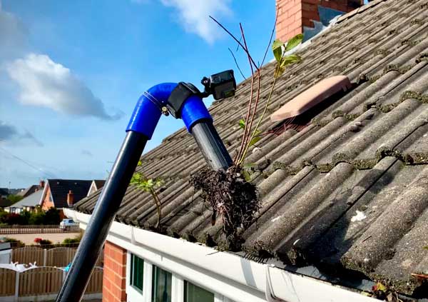 Extracting dirt from a gutter with a remote cleaning tool