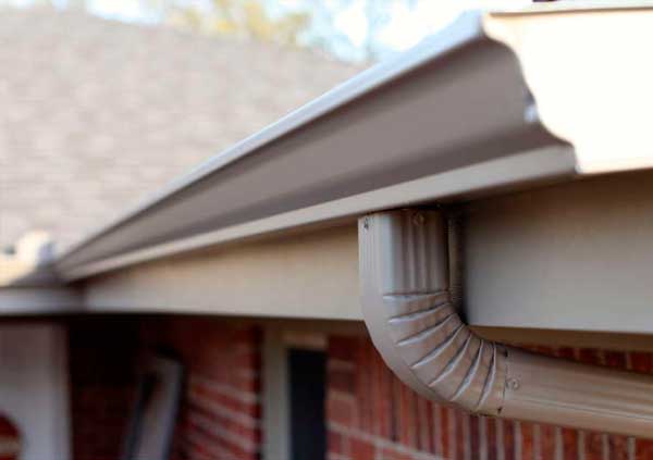 White metal gutter in a red bricks house