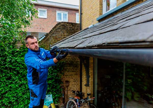 Operator installing a guttering system