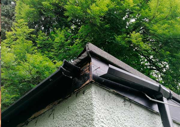 Black metal gutter broken in a corner