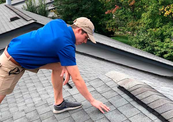 Worker checking the state or a roof