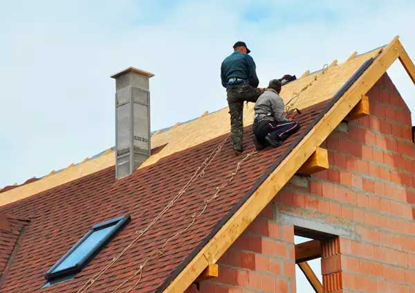 Roofers tiling an entire roof