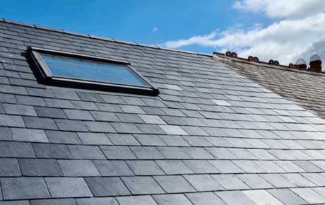 Shimmering black slates roof with window