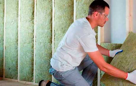 Operator installing attic insulation