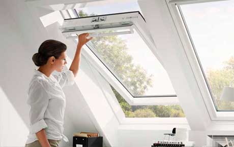 Woman opening a Velux Window