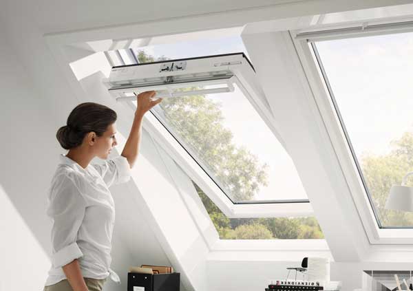 Woman opening a Velux Window