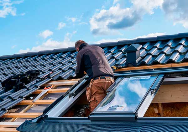 Operator installing new Velux Windows in Cork