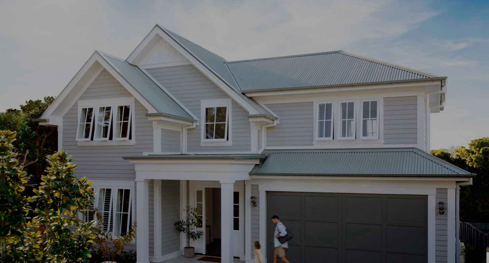 Gray & White house with a black metal roof 